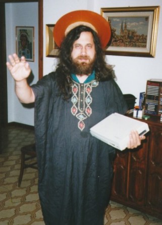 Richard Stallman wearing a halo, holding a book, looking like a christian saint