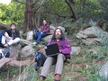 RMS outside on a lush rocky hill with his laptop.